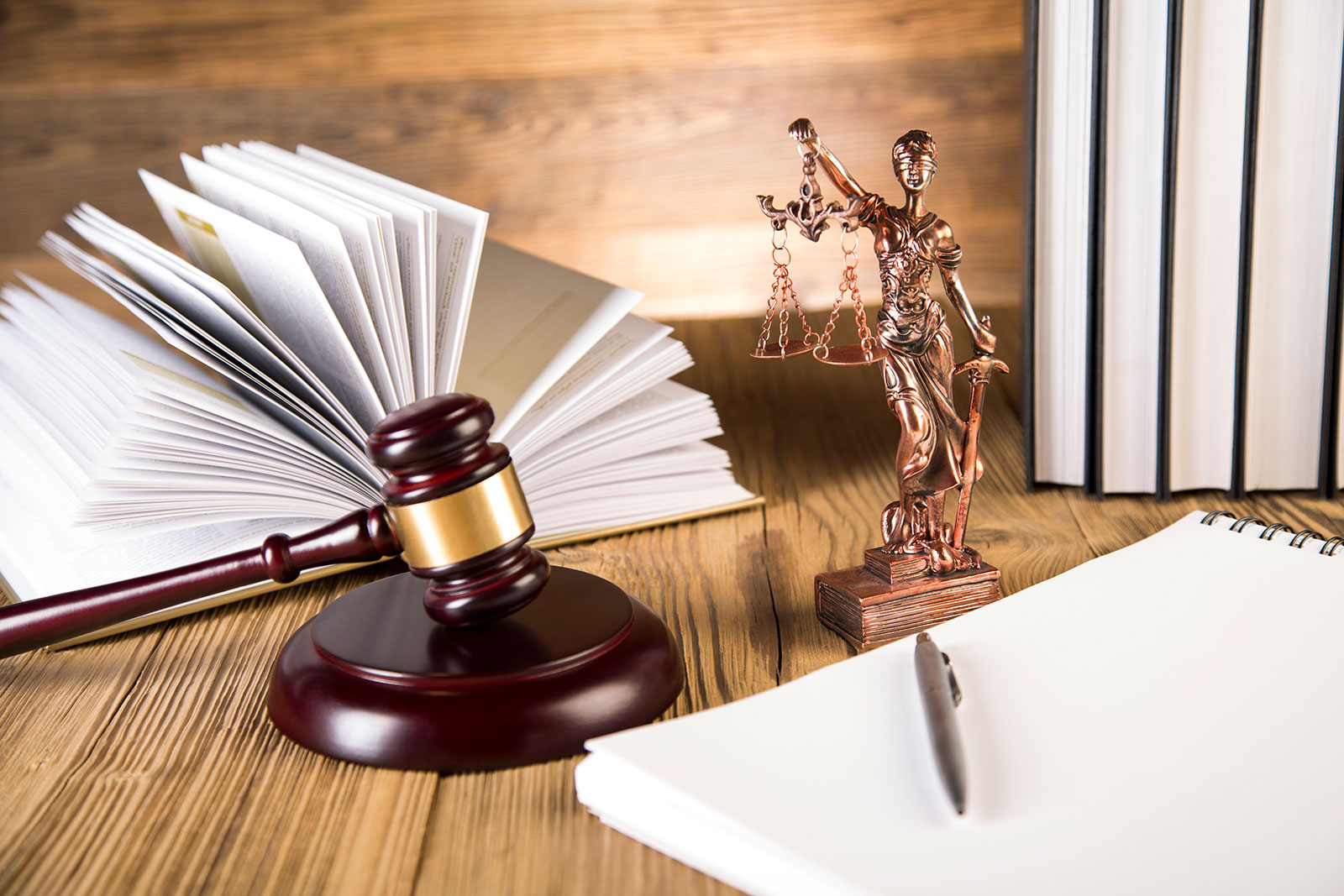 statue, book and gavel sitting on desk