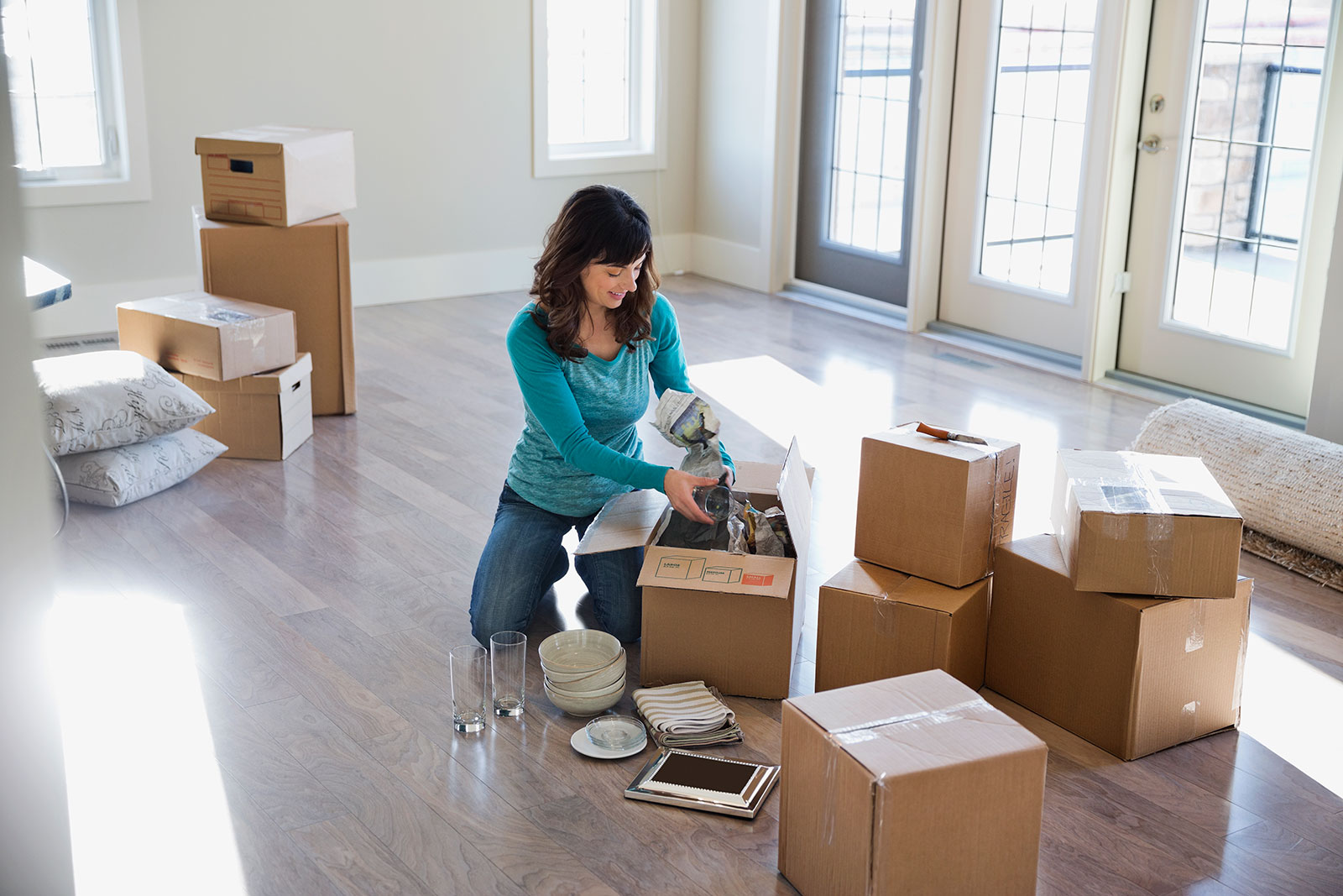 woman unpacking boxes in new home