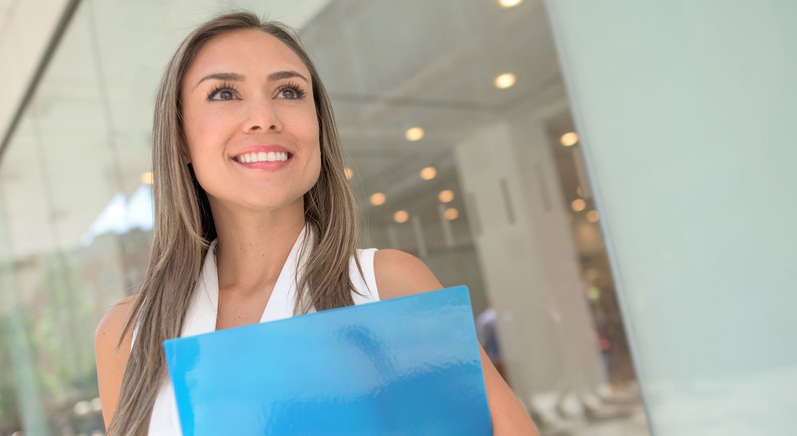smiling woman holding folder